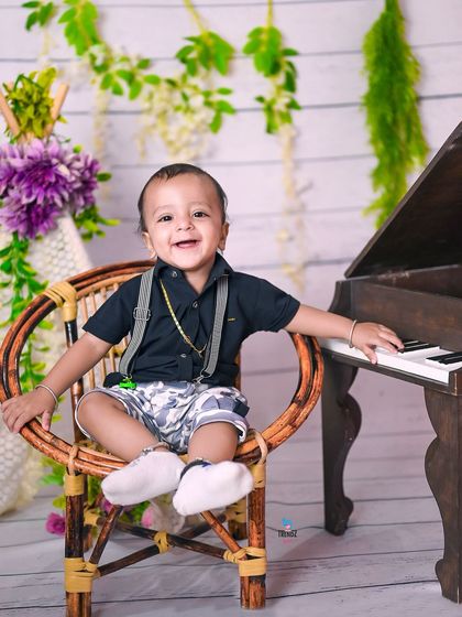 A duplicate of image 206, a happy little musician at his birthday shoot.