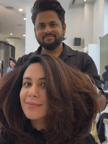 A smiling selfie with her new fresh look. The rich brown color and voluminous styling create a happy and confident vibe.