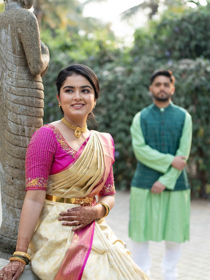 A beautiful portrait of the bride with her groom in the background. Her makeup is soft and romantic, creating a dreamy and picturesque scene.