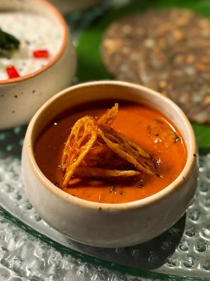 A tangy and flavorful curry from our Navratri Thali, garnished with crispy lotus stem chips. We focus on texture as much as flavor in our festive menus.