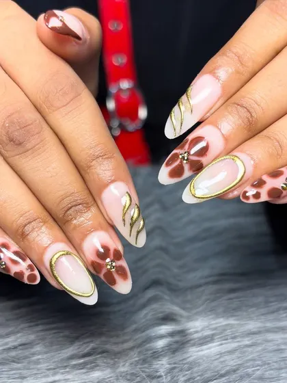 A creative and artistic set featuring a mix of tortoise shell print, hand-painted flowers, and 3D gold chrome accents on a sheer base.