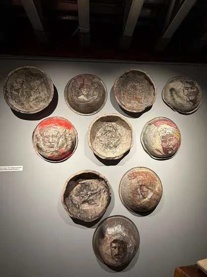 What does a 'tasla' (pan) carry? At our sites, it carries saplings and soil. Reimagined by artists, these recycled taslas now carry faces and stories, reminding us of the human effort behind every act of care.