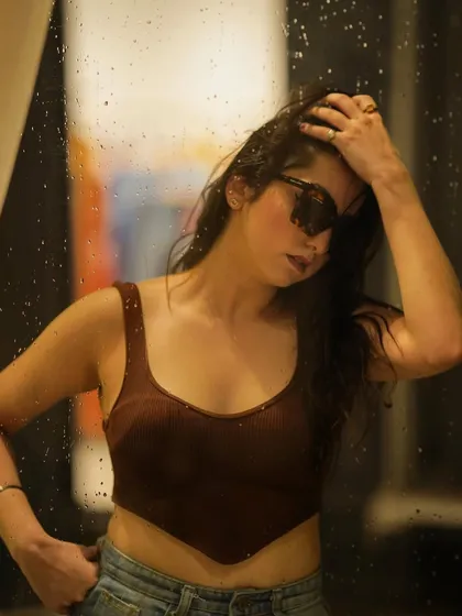 A moody shot against a window, creating a more artistic and thoughtful feel.