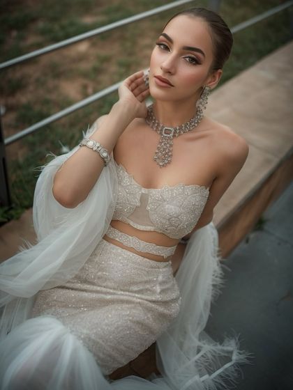 Another shot of the white glam look. The feathered dupatta adds a touch of high fashion.