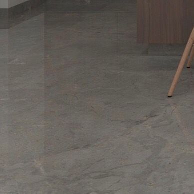 The reflective surface of a polished stone floor. My material choices prioritize longevity and low maintenance, ensuring the spaces I design are as practical as they are beautiful.