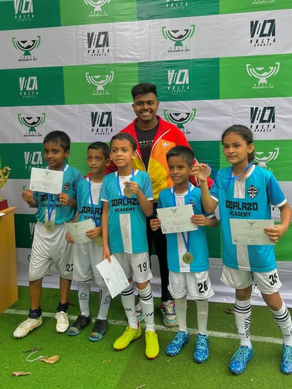 Our Under-9 team with their certificates and medals after securing third place at the Grassroots Cup.