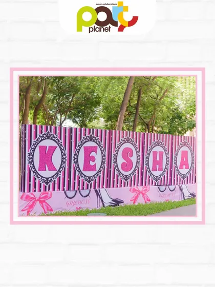 A personalized backdrop for a Barbie party, with the birthday girl's name in bold pink letters against a stylish striped pattern.