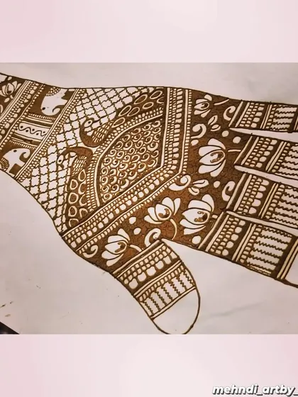 Here is another design concept on paper. This sketch helps me visualize the flow of the pattern across the hand, ensuring the peacocks, florals, and geometric fills work together harmoniously.