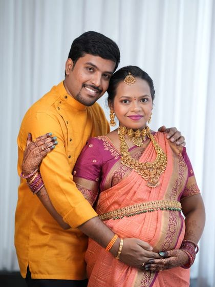 A lovely couple portrait. Varsha's choice of classic temple jewellery adds a touch of timeless elegance to her baby shower celebration.