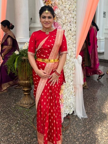 The gorgeous Amulya in a red bandhani saree, paired with a bespoke red blouse with delicate white embroidery.