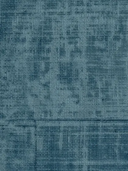 The textured weave of coated raffia from Élitis captures the essence of artisanal craftsmanship. This swatch in a vibrant teal hue shows how tradition can be blended with modern, refreshing color.
