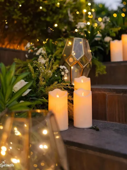 Candlelit stairs and geometric lanterns add a warm, inviting glow to the reception space.