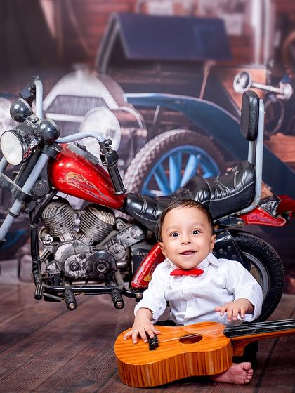 A biker and a musician all in one. This little boy combines his love for cool rides and sweet tunes in this creative, vintage-themed shot.