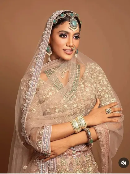 This editorial bridal look focuses on the artful integration of hair and jewelry. I styled the hair in a clean, pulled-back fashion to allow the elaborate matha patti and sheer dupatta to take center stage, creating a regal and timeless portrait.