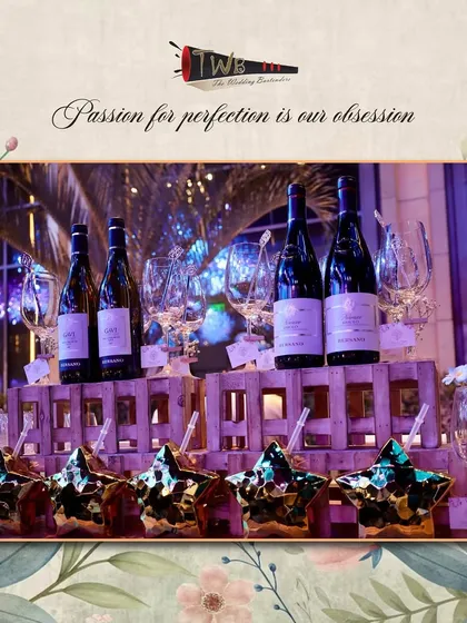 A sophisticated bar display with premium wines and star-shaped glasses for a Sangeet celebration.