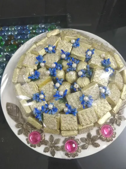 A beautiful platter of my handmade wedding chocolates. These are wrapped in gold foil and decorated with delicate blue and pearl flowers, making for an elegant addition to any sagan ceremony or as a standalone sweet gift.