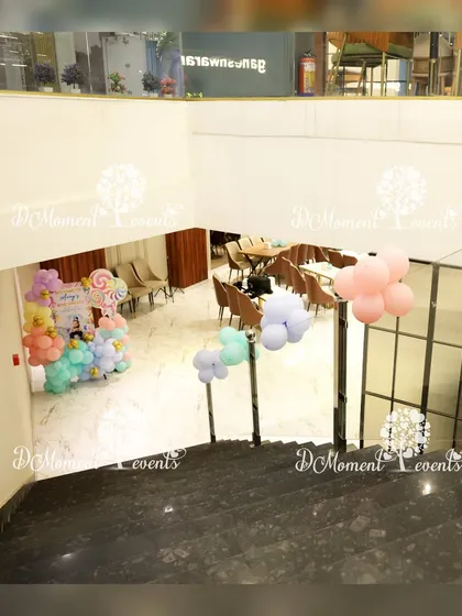 A view from the top of the stairs showing the Candyland party setup below. This angle gives a sense of the space and the placement of the colorful decorations.