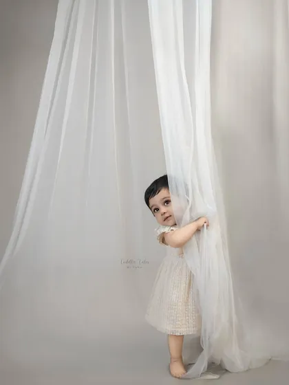 A shy, curious peek from behind the curtain. I take things slow and gentle, allowing little ones to get comfortable and let their true personalities emerge at their own pace.