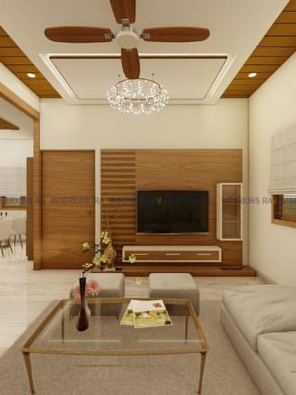 This living area features a minimalist TV unit and a beautiful CNC-cut jali partition. The design prioritizes clean lines and a sense of openness.