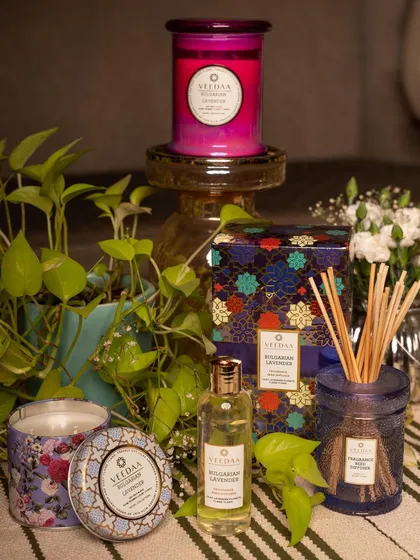Bring the scent of a summer garden into your home. This image showcases our Bulgarian Lavender products, including a tin candle, glass candle, and reed diffuser, surrounded by lush greenery.
