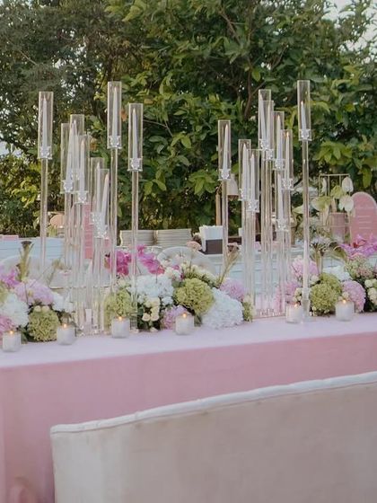 The buffet table at the Lagan Lakhwanu ceremony, adorned with soft pink linens, lush florals, and elegant glass candelabras. The design was all about understated elegance.