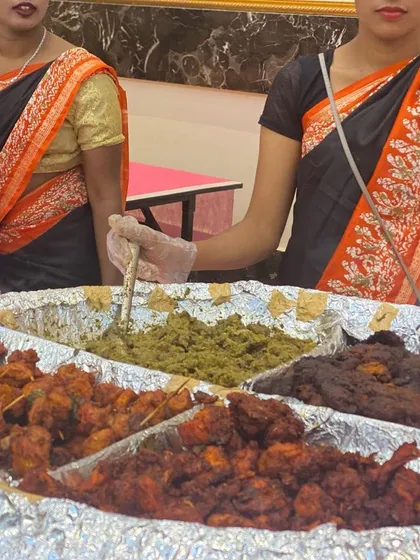 A close-up of our assorted non-vegetarian starters, a crowd favorite at wedding receptions. This platter features a variety of kebabs and fried items, each seasoned and cooked to perfection by our expert chefs.