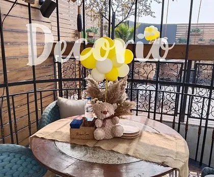 Here is a closer look at a table centerpiece I created for a baby shower. The simple balloon bouquet and small teddy bear add a festive touch to the guest tables without being overwhelming.