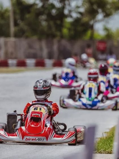 Abhay leads a pack of karts during a competitive race, showcasing the racecraft and strategic positioning taught at our academy.