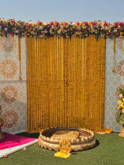 For a classic and traditional haldi function, we use beautiful marigold flower curtains and ornate brass urlis. This decor style honors tradition while still feeling elegant and picture perfect.