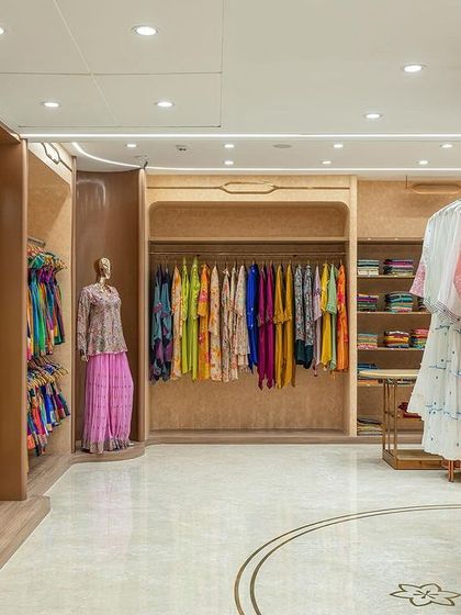 The layout of the second floor is open and fluid, allowing customers to move easily between different collections. The design uses a combination of hanging displays and mannequins to showcase the outfits.