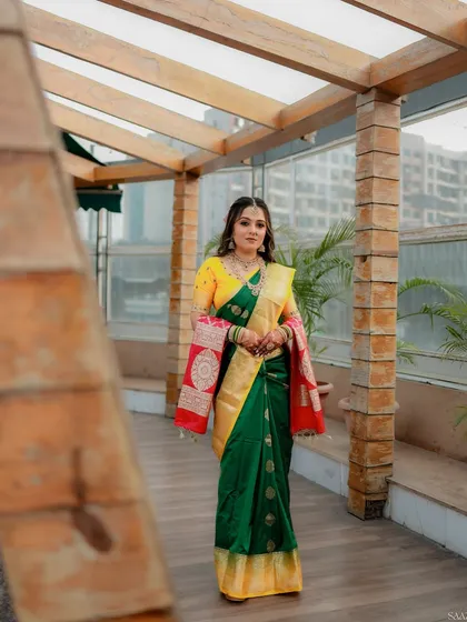 The bride poses on a terrace, her traditional attire looking beautiful against the modern backdrop.