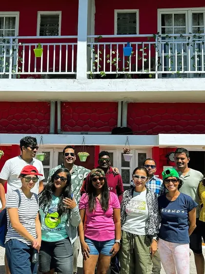 The group outside our vibrant red homestay in Kodaikanal.