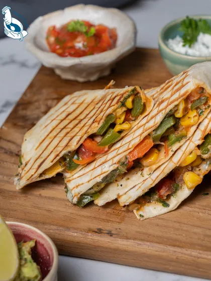 A classic comfort food, my quesadillas are always a hit. Grilled tortillas filled with cheese and a savory vegetable mix, served with salsa and guacamole, they are perfect for a relaxed corporate lunch or party.