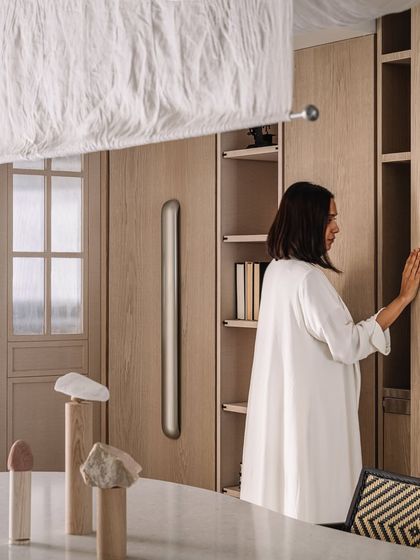 A personal moment in the dining room, showing how the space is meant to be lived in and enjoyed. The design serves as a backdrop to the client's life.