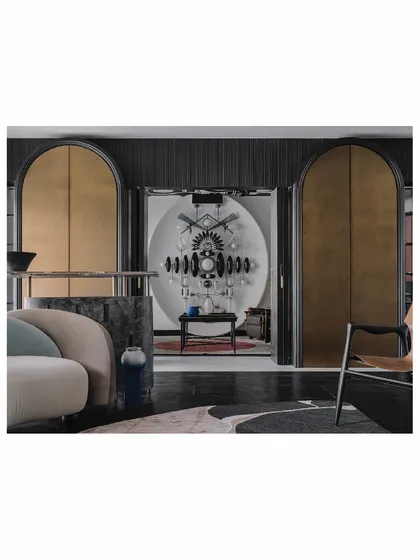 From this perspective, you can see how the symmetrical cabinets in the 'Aria' living room create a formal frame for the dramatic light installation in the adjacent room. This layering of spaces adds depth and a sense of discovery to the home's layout.