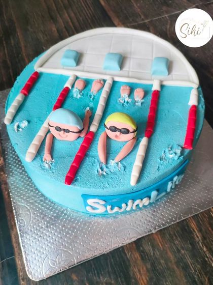 A cake celebrating a 76-year-old swimmer. This design depicts a swimming pool with swimmers in their lanes, all created with buttercream and fondant.