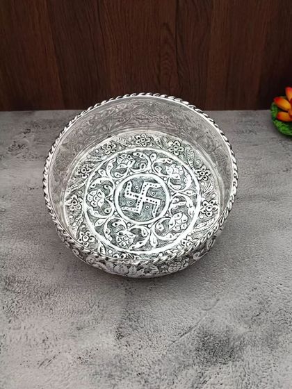 A duplicate image of the antique German silver urli with a swastik design.