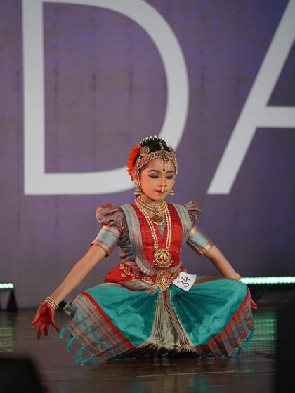 A young student in a deep sitting posture, showcasing her focus and control. Her performance earned her a 1st place award in the minor category.