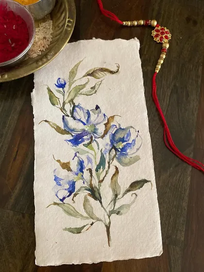 A simple watercolor floral painted on handmade paper, created as a card for Rakhi. Handmade art is a wonderful way to send love on special occasions.