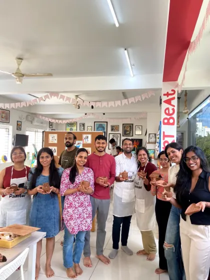 A group of participants with their finished clay creations. The smiles on their faces show the joy of making something with their own hands.