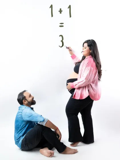 A fun and creative way to announce the big news! The couple uses a simple equation, "1+1=3," for a playful and heartwarming pregnancy announcement.