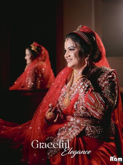 A stunning portrait of the bride in her red Muslim bridal attire, looking at her reflection. The title "Graceful Elegance" perfectly suits the image.