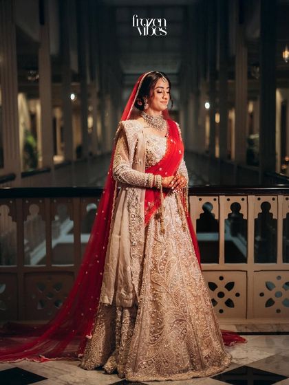 An elegant full-length portrait of the bride in the grand hallway. The classic setting complements her timeless bridal look perfectly.