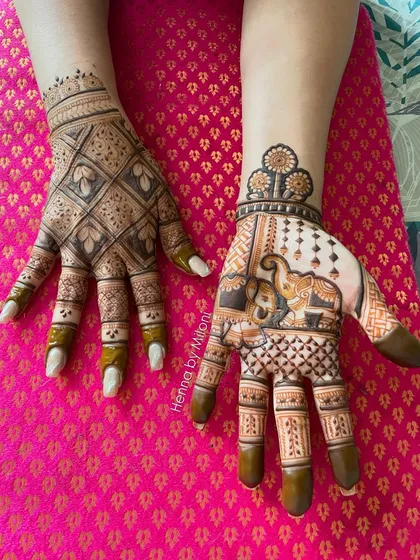 A fun and creative Karva Chauth design. One hand features a traditional geometric pattern, while the other has a playful elephant motif.