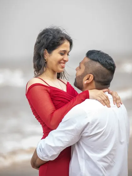 An intimate close-up during a pre-wedding session by the sea. The soft light and their gentle expressions make this a truly romantic and heartfelt portrait.