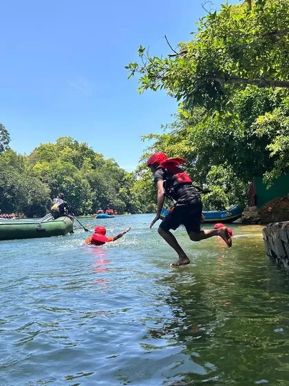 A camper takes a running jump into the river, a fun and exhilarating activity during our Dandeli summer camp.
