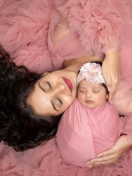 A mother's love is a masterpiece. This artistic portrait of a mother and her newborn, wrapped in matching soft pink, is one of my favorite ways to show that deep, peaceful bond. Pure and simple love.