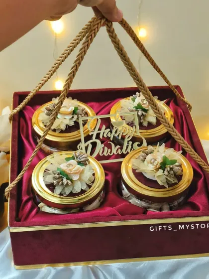 This premium velvet box with four jars of high-quality dry fruits is a client favourite. It's the perfect blend of luxury and tradition, making it an ideal corporate Diwali gift for your most valued clients and partners. The floral detailing on the lids adds a special, handcrafted touch.