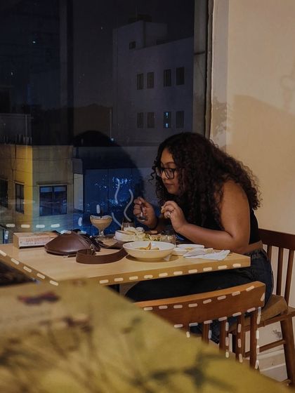 A quiet dinner for one by the window, watching the city lights. Our cafe is a peaceful sanctuary for those moments when you just want to enjoy a good meal by yourself.