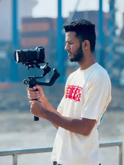 A shot of me operating a camera on a gimbal during an outdoor shoot, ensuring smooth and cinematic footage.